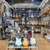 A colorful guitar store interior showcasing a wide range of guitars on display. Perfect for music enthusiasts.