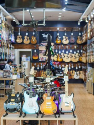 A colorful guitar store interior showcasing a wide range of guitars on display. Perfect for music enthusiasts.